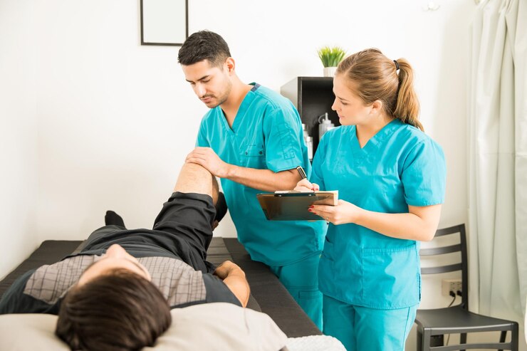 young physiotherapist examining customer s leg while colleague noting clipboard hospital 662251 1651